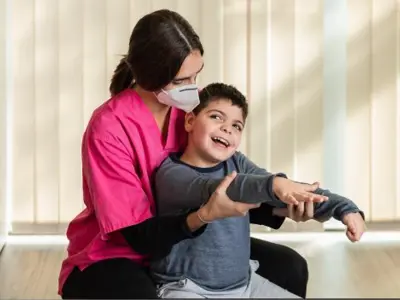 disabled-child-and-physiotherapist-on-top-of-a-pea-2022-05-08-22-01-50-utc.jpg