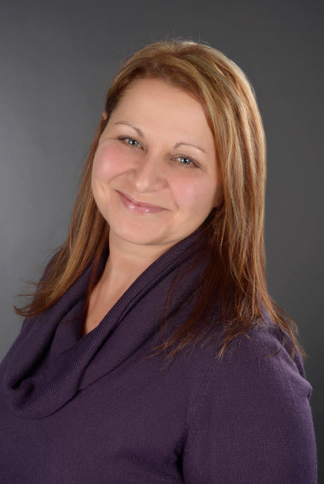 Woman with long hair wearing a purple sweater