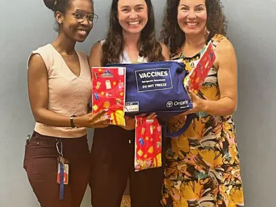 Three-healthcare-staff-CHC-blue-vaccine-box.jpeg
